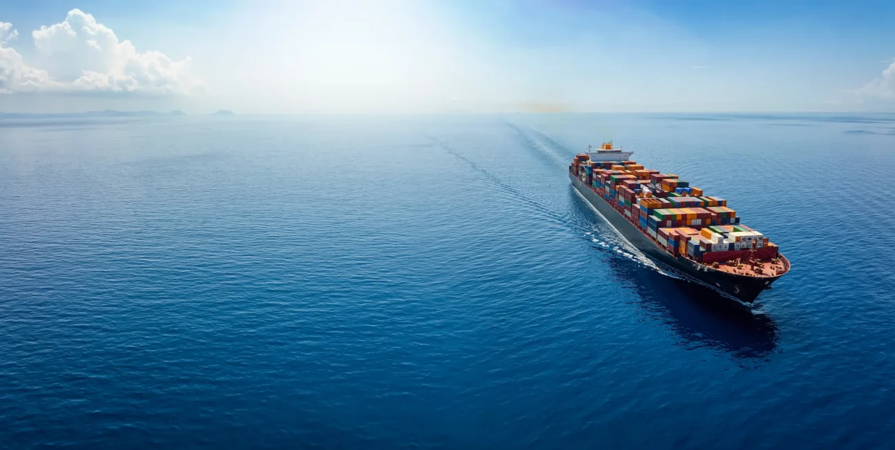 A large container ship transporting building materials across the ocean, representing global sourcing from China.