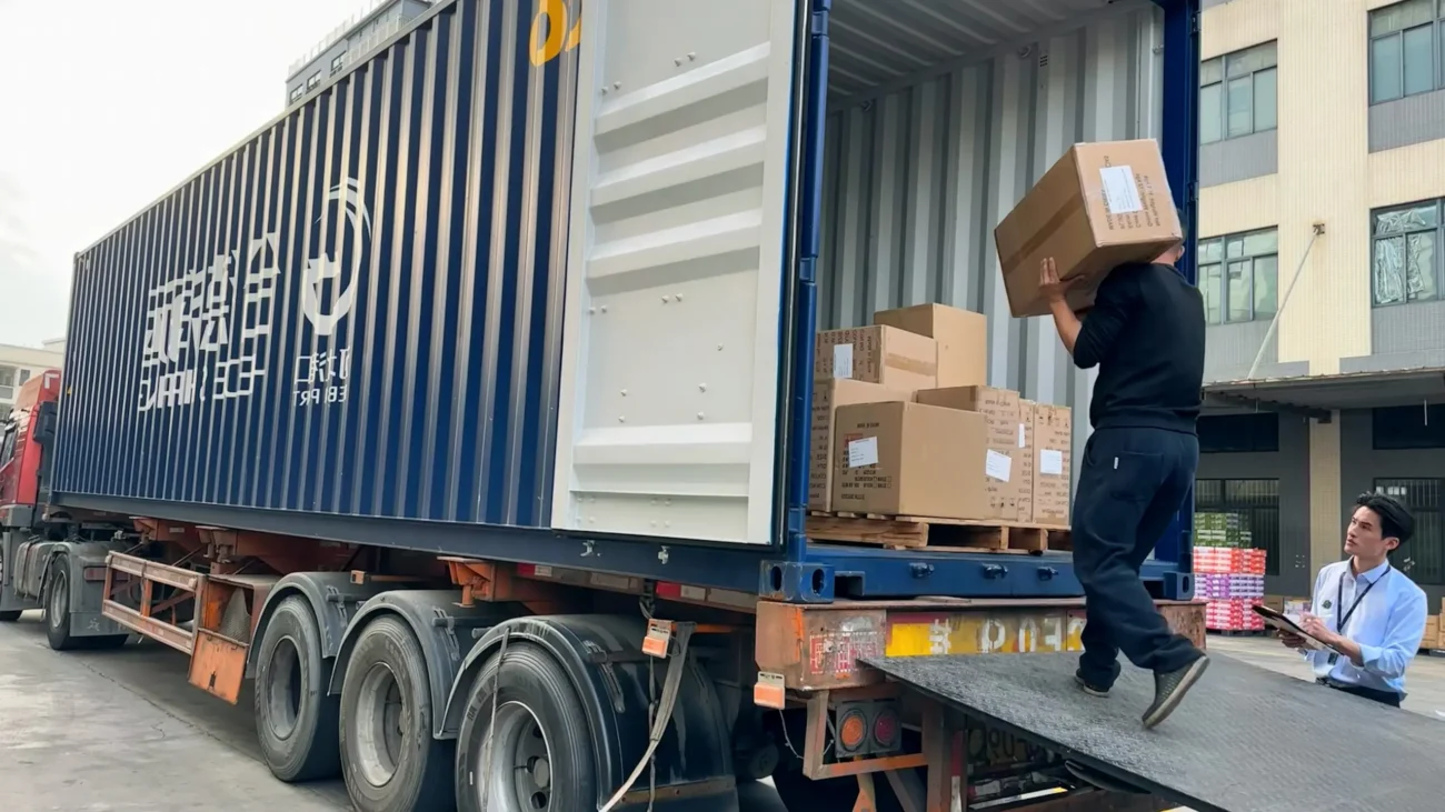 How to Buy Villa Renovation Materials from China – Complete 2025 Guide 3 Workers loading cartons into a shipping container at a Chinese warehouse
