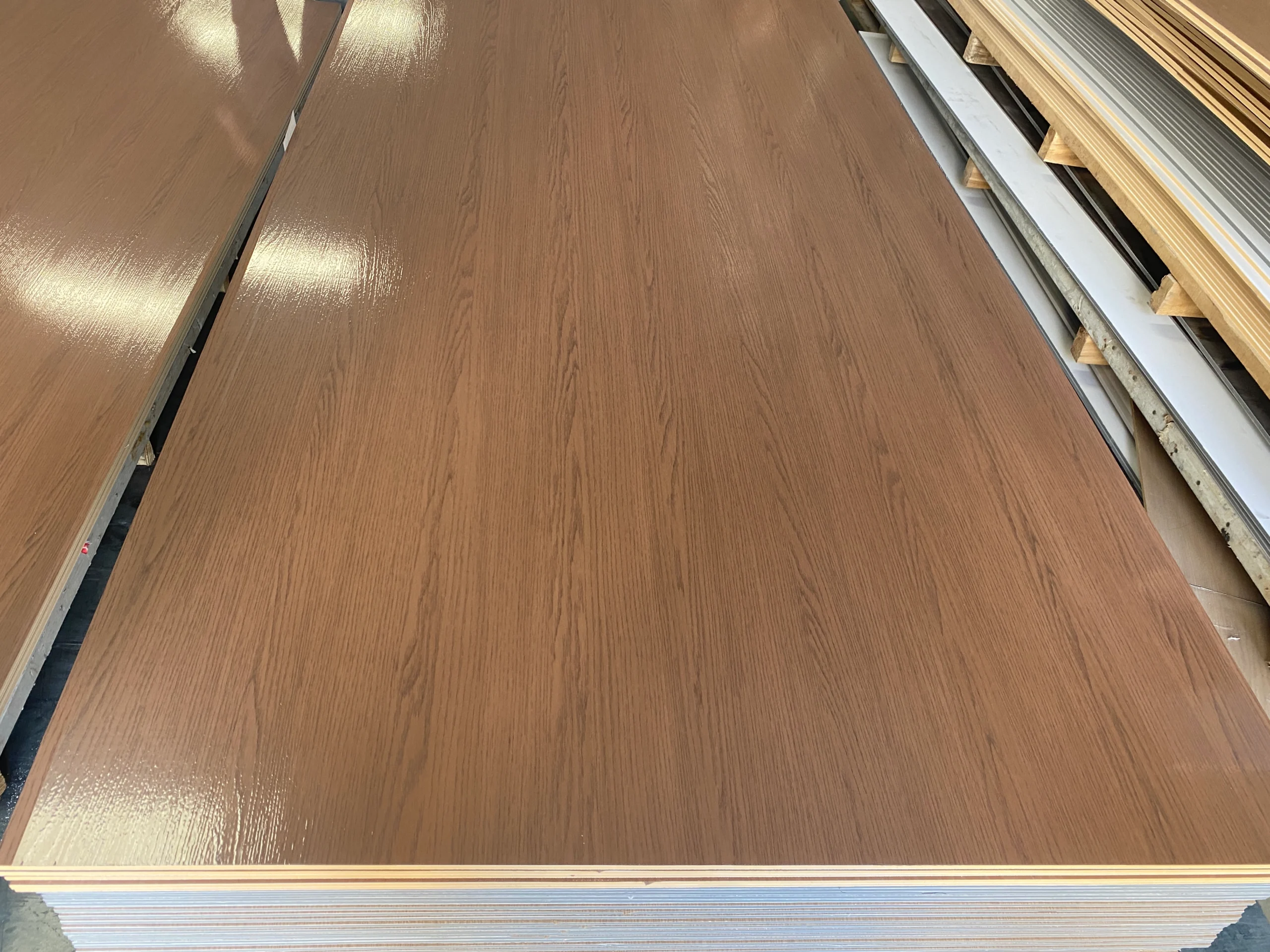 French Château Renovation: How We Sourced Furniture and Building Materials from China 5 Stacked brown wood-grain panels showing surface finish and layered edges